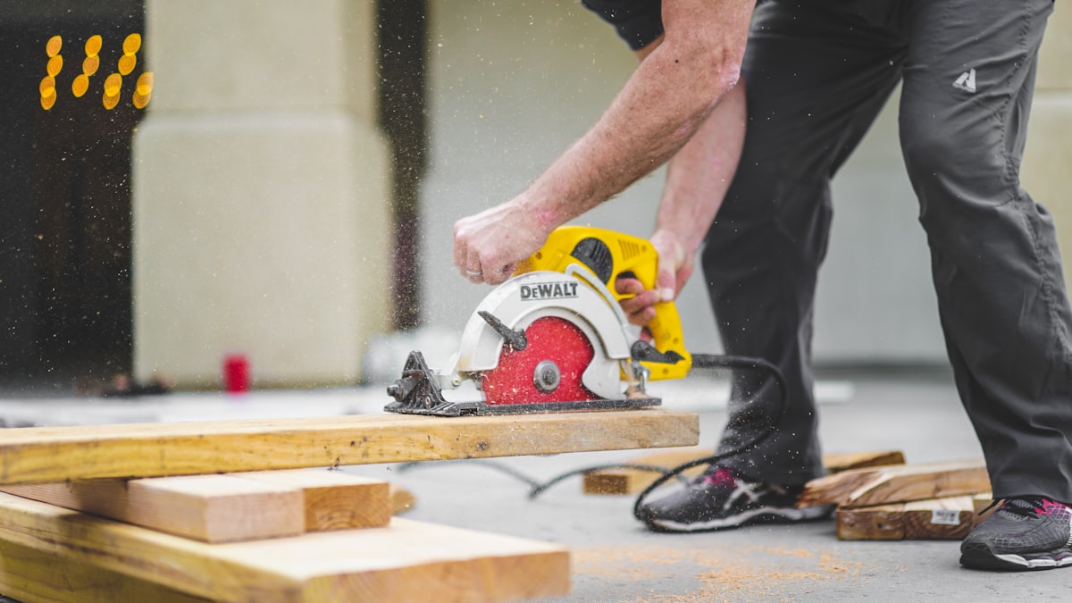 Circular saw cutting a deck board, sawdust in the air